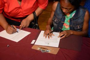 November 2016 Quarterly Newsletter REACH Signing Day - Signing shot_1.jpg